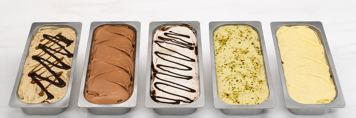 Five pans of artisanal gelato with assorted flavors and toppings