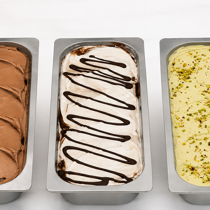 Five pans of artisanal gelato with assorted flavors and toppings