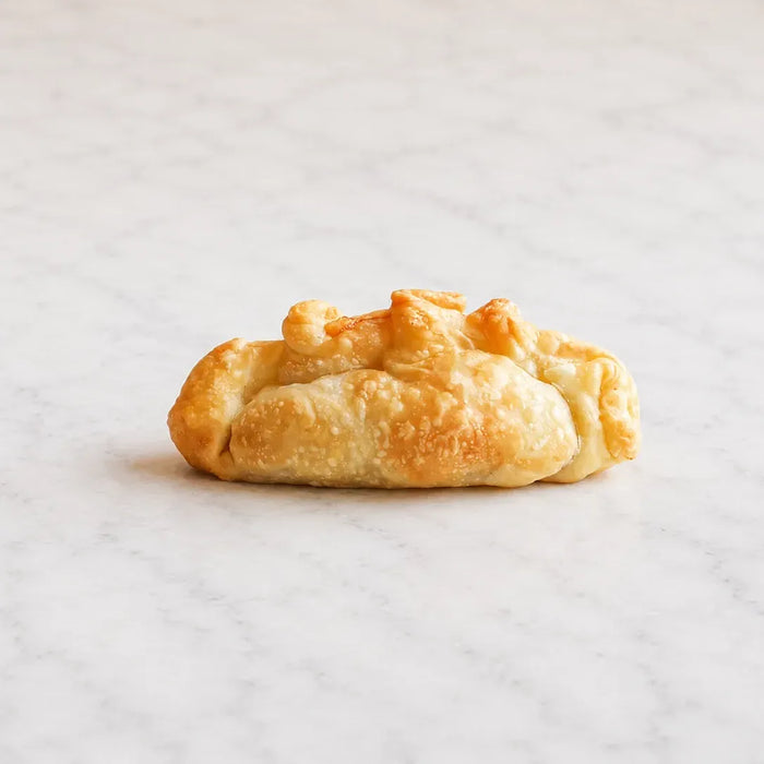 PF Empanadas egg and cheese empanada cut open to show the breakfast filling